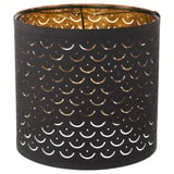 Der schwarze NYMÖ-Lampenschirm, kreisförmig mit goldener Innenseite und Mondausschnitten, erzeugt dekorative Lichtmuster. Hergestellt aus Polyester, Stahl und Kunststoff.