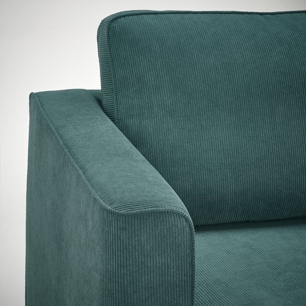 Nahaufnahme der türkisfarbenen Sofaecke, die plüschigen, strukturierten Stoff und robuste Verarbeitungsqualität zeigt.