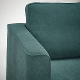 Nahaufnahme der türkisfarbenen Sofaecke, die plüschigen, strukturierten Stoff und robuste Verarbeitungsqualität zeigt.
