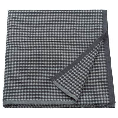 Tagesdecke aus grau karierter PELARTUJA-Baumwolle, wendbar, quadratische Form mit Waffelgewebestruktur.