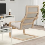 Minimalistisches Wohnzimmer mit Holzsessel auf weißem Teppich, Glastisch mit Büchern und Wasser.