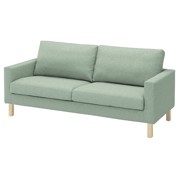 Grünes, modernes Sofa mit leichten Holzbeinen, quadratischen Kissen.