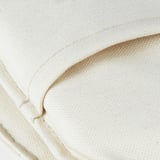 Nahaufnahme eines weißen Kissens, das seine Textur und Nahtdetails zeigt.