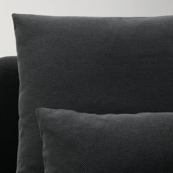 Dunkelgraues, modernes Sofa mit weichen Kissen, das sich durch schlankes Design und hochwertige Stoffe auszeichnet.