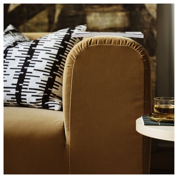 Elegantes Sofa mit braunem Samt, Plüschkissen und schwarz-weißen Kissen, das zum Entspannen einlädt.