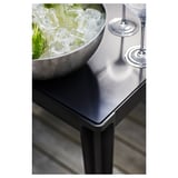 Moderner Outdoor-Tisch mit metallischer Schale aus Limetten und Gläsern.