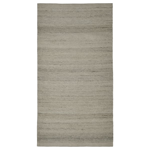 Grauer flachgewebter Teppich, rechteckige Form, dezentes Streifendesign, aus Baumwolle und Wolle.