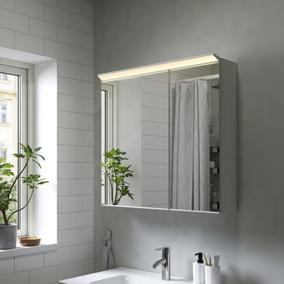 Moderner grauer TREASJÖN Spiegelschrank mit LED-Beleuchtung und großer Reflexion.