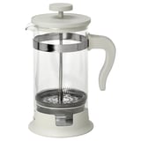 Eine weiße French-Press-Kaffeemaschine mit einem durchsichtigen Glasgefäß, einem Netzfilter aus Edelstahl und einem Deckel, einem Griff und einem Sockel aus Kunststoff.