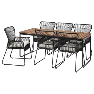 Schwarze Outdoor-Essgarnitur mit Holztisch und Korbstühlen, modernes Design.