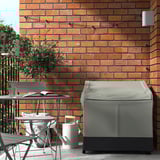 Moderner Balkon mit grauer VÄTTERSÖ Aufbewahrungsbox und Tisch an Backsteinwand.