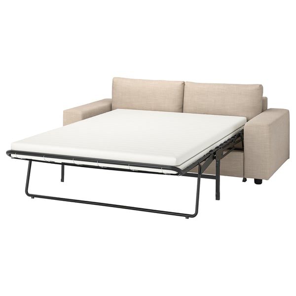 Modernes beiges Schlafsofa mit hellgrauen Kissen, schlanken Linien und Metallrahmen.