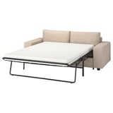 Modernes beiges Schlafsofa mit hellgrauen Kissen, schlanken Linien und Metallrahmen.