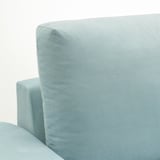 Ein hellblaues Sofa mit robusten, einladenden Kissen vor einem schlichten weißen Hintergrund.