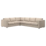 Modernes cremefarbenes Ecksofa, beige, schlankes Design, Plüschkissen, L-förmig.