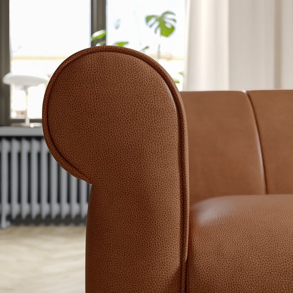 Braune Ledercouch, runde Armlehnen, Vintage-Design.