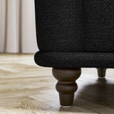 Schwarzes VISKAFORS Sofabein, rundes Holzdesign.