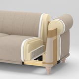 Der Querschnitt des Sofas zeigt Schichten: Oberstoff, Schaumstoff, Holz, Kunststoff und mehr Schaumstoff, um die Konstruktion zu veranschaulichen.