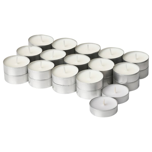 Collection of white ADLAD candles in silver holders, round and stacked in a cluster.