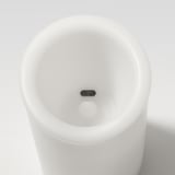Modern white block candle with subtle motion sensor button for automatic operation, sleek, minimalist design.