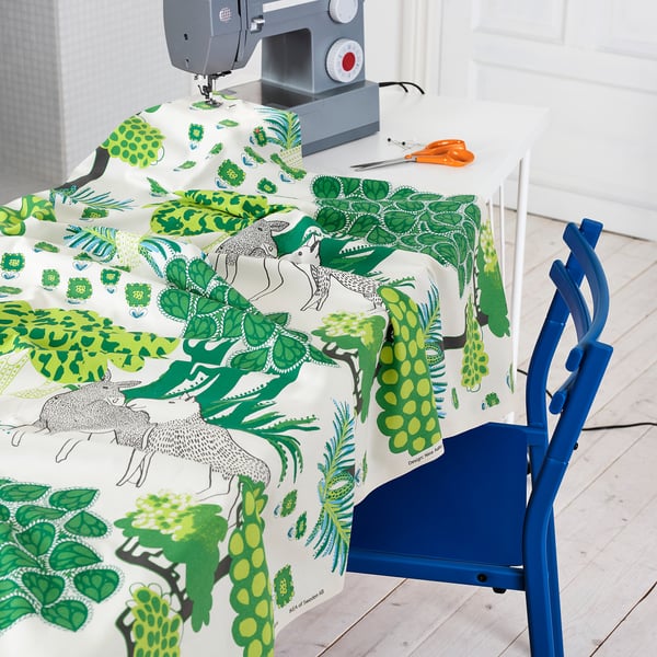 Sewing setup with table, chair, and supplies