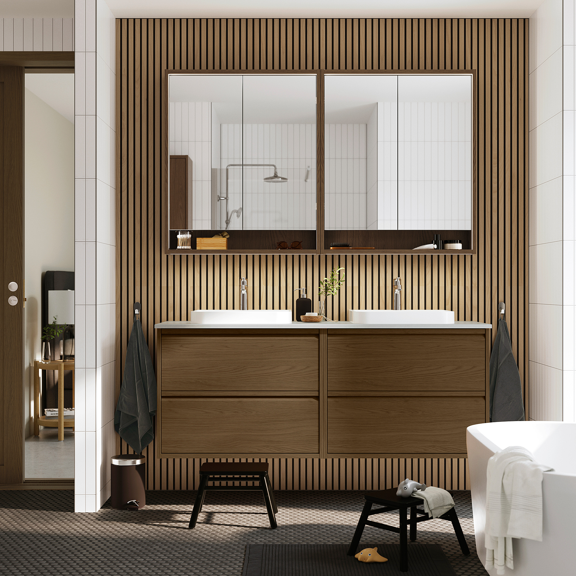 Modern bathroom: brown cabinet, 2 sinks, mirrors, black stool, towels. Minimalist design.