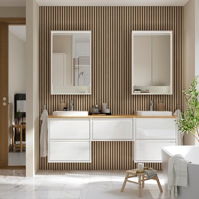 Modern bathroom with ÄNGSJÖN white cabinet, two sinks, and vertical stripes; sleek design.