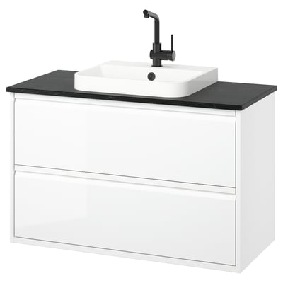 Modern white bathroom vanity with sleek black countertop and square basin, wall-mounted with minimalist design.