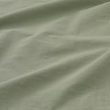 Soft, green pillowcase in close-up, showcasing smooth, high-quality cotton fabric with light folds.