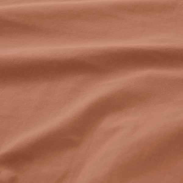 Smooth, reddish-brown bed sheet texture, showcasing soft cotton quality.
