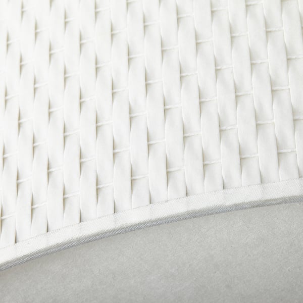 Close-up of ALÄNG lamps textured, pleated white shade, showing intricate design and quality craftsmanship.