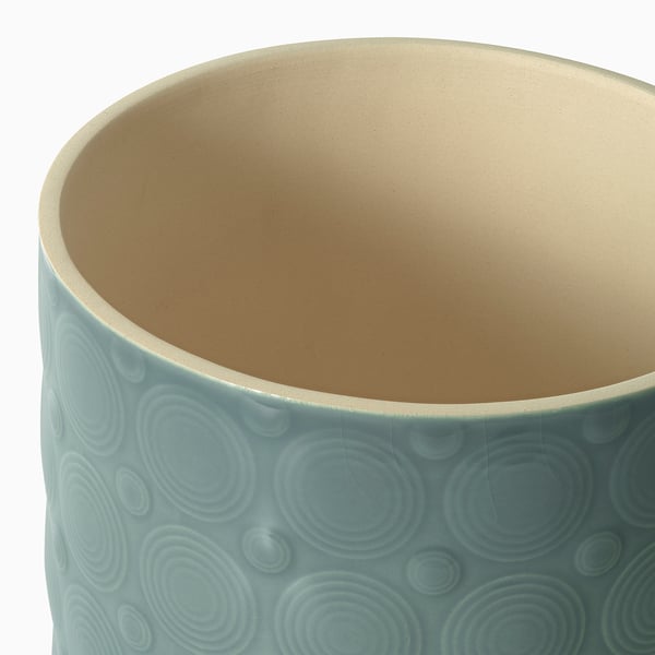 Cylindrical planter with textured, glazed surface; soft blue exterior, light tan interior; quality craftsmanship visible in smooth finish.