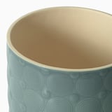 Cylindrical planter with textured, glazed surface; soft blue exterior, light tan interior; quality craftsmanship visible in smooth finish.