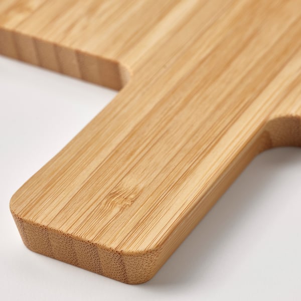Light wooden cutting board with smooth, slanted edges.
