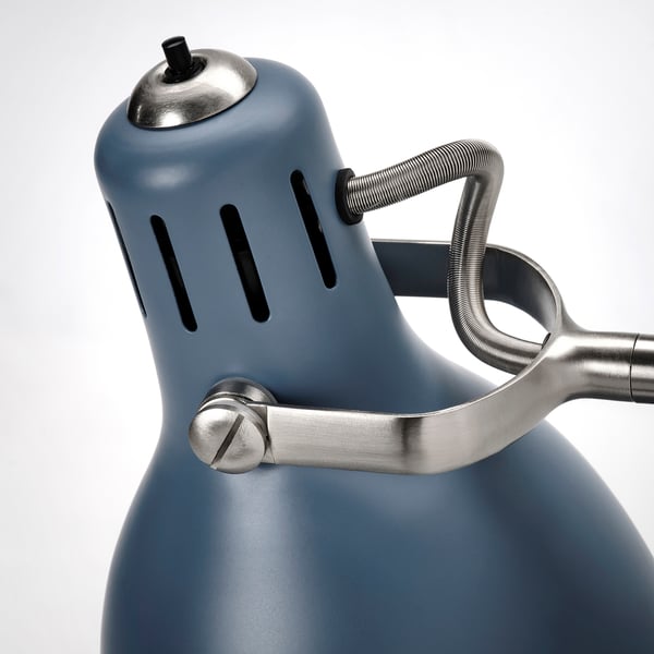 Blue floor lamp with adjustable metal arm, featuring quality steel and nickel-plated details.
