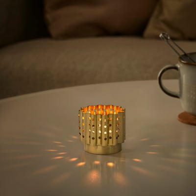 AROMATISK brass-colored tealight holder, wavy design, small size, stainless steel, emits soft light, table decoration.