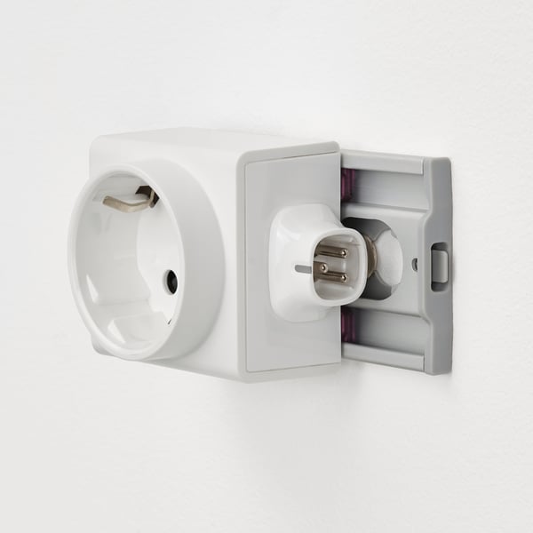 Wall-mounted electrical socket with on/off switch and removable adapter.