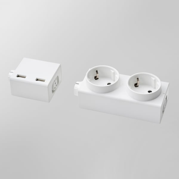 Two white ÅSKVÄDER power modules are displayed, one with dual usb ports and the other with two schuko sockets.