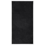 A black rectangular BACKMÅRA bath mat made of recycled polyester, featuring a soft pile and latex backing.