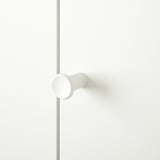 White modern handle on clean door, minimalist design.