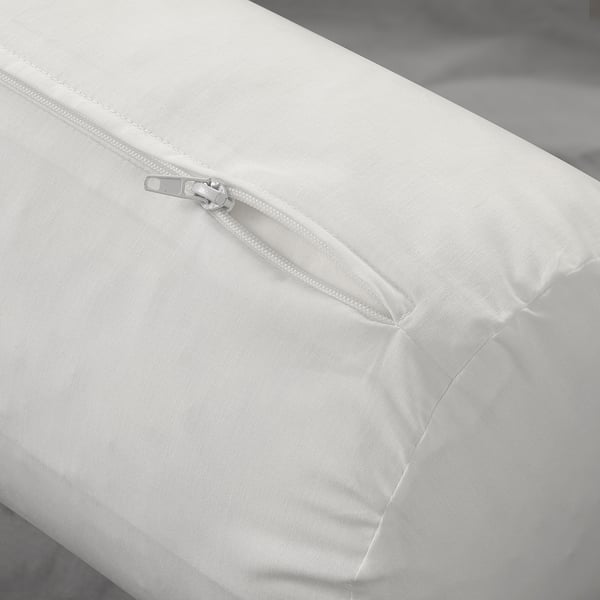 Close-up of a white pillow, showcasing its zipper and soft, plush fabric, designed for comfort and relaxation.