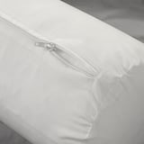 Close-up of a white pillow, showcasing its zipper and soft, plush fabric, designed for comfort and relaxation.