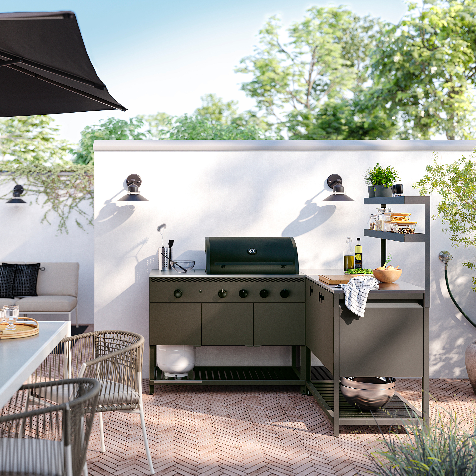 Small, green BÅTSKÄR outdoor kitchen setup with shelves and gas grill. Perfect for cooking and storage in a neat, organized outdoor space.