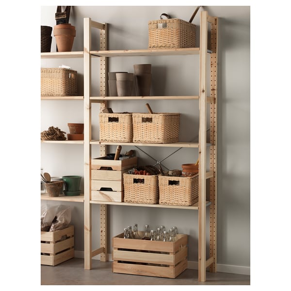 Shelf with woven baskets and crates in off-white, wood and rattan, holding gardening supplies.