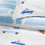 Childs duvet cover with colorful vehicles on white. Soft, breathable cotton, zipper closure.