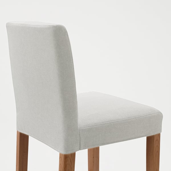 A single, stylish bar stool with a light gray upholstered seat and backrest, supported by sturdy wooden legs.