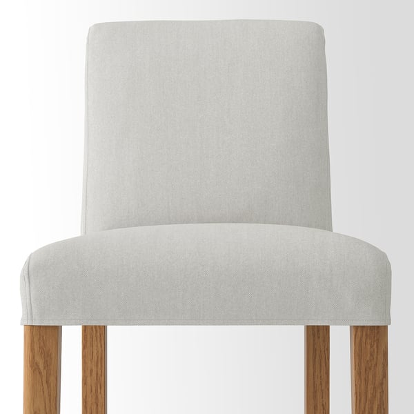 A modern grey upholstered bar stool with comfortable cushions and sturdy wooden legs.