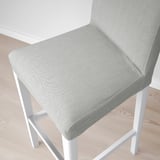 Modern bar stool with cushioned seat and back, light grey fabric, white frame, stylish and comfortable.