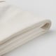 Folded white cotton cloth on white surface. Fabric appears smooth, woven, and clean.