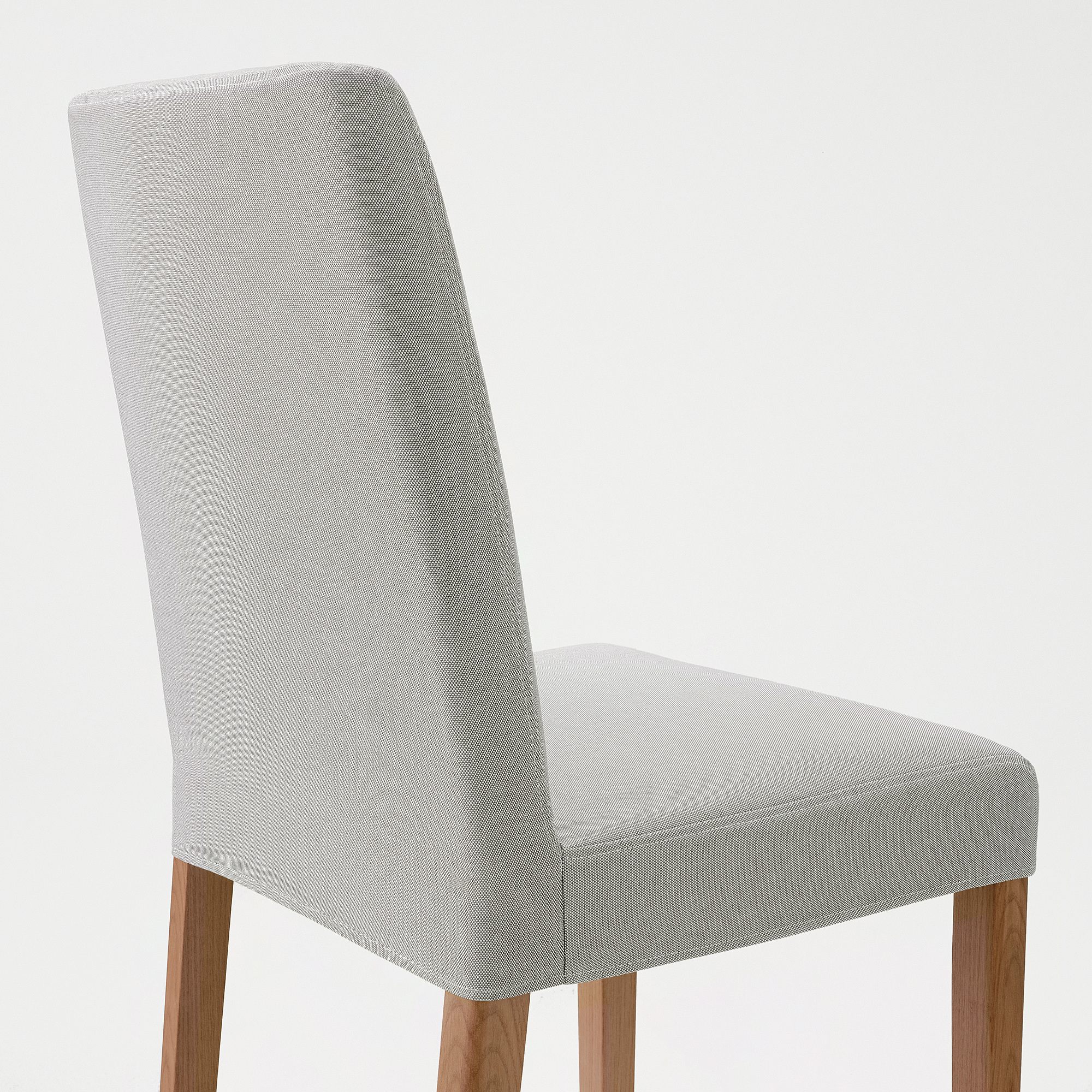 Modern upholstered chair with light grey fabric and light wood legs, demonstrating high-quality comfort and design.
